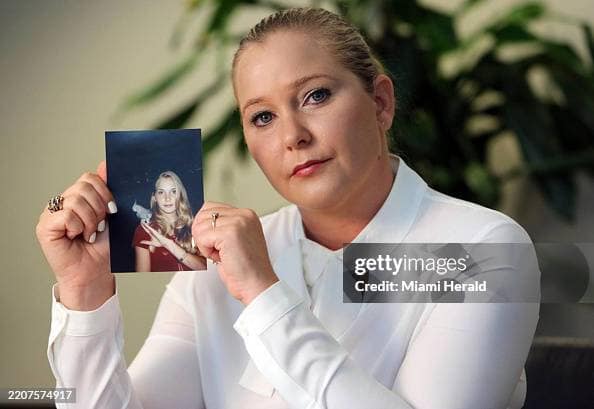 Virginia Giuffre, with a photo of herself as a teen, when she says she was abused by Jeffrey Epstein, Ghislaine Maxwell and Prince Andrew, among others. (Emily Michot/Miami Herald/Tribune News Service via Getty Images)